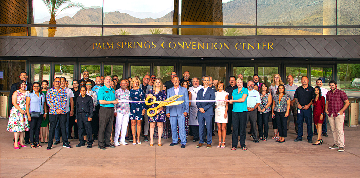 Ribbon cutting in the front of the Palm Springs Convention Center with Mayor Christy Holstege, City Manager Justin Clifton, Nona Watson - CEO of the Palm Springs Chamber of Commerce, and community members.