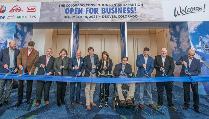 Denver leaders celebrate the completion of the Colorado Convention Center (CCC) expansion with a ribbon cutting ceremony.  Pictured left to right: Adam Phipps, DOTI; Greg Feasel, CO Rockies Baseball Club; Jason Lusk, VISIT DENVER; Gretchen Hollrah CCD – Mayor’s Office; Richard Scharf, VISIT DENVER; Mayor Mike Johnston; Amanda Sandoval, Denver City Council District 1; Chris Hinds, Denver City Council District 10; Jason Wallack, Hensel Phelps Const.; Rob Svedberg, TVS Design; Lance Zanett, ASM Global. (PIC: https://www.denver.org/articles/post/colorado-convention-center-expansion-complete-and-open-for-business/)