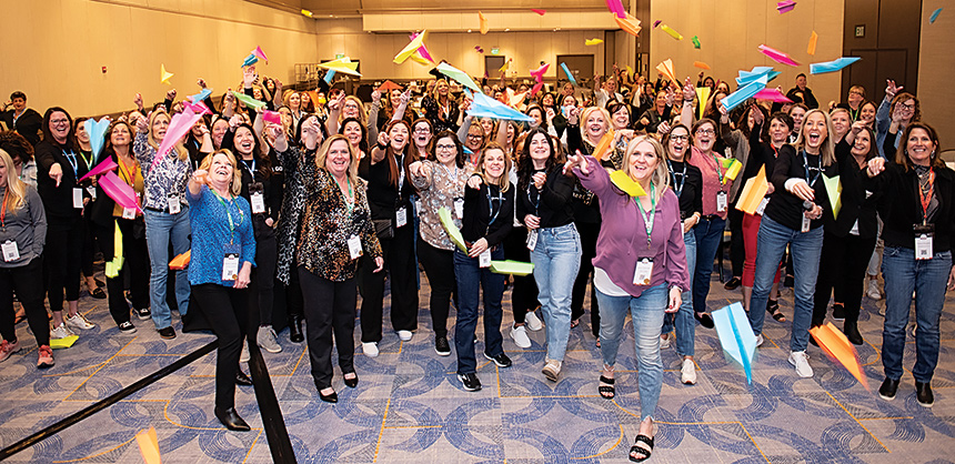 Apps have reduced the need for paper booklets. “Know Before You Go” documents and other information are available digitally. Pictured: At the 2024 Facilisgroup’s emPOWER Women’s event, attendees find creative uses for paper. Photo by Jason Office